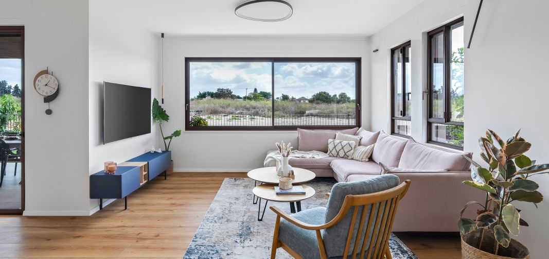 חלונות ודלתות הזזה מסדרת 7600 ובסגנון באוהאוס מאפשרת כניסה של אור טבעי ונוף לתוך הסלון